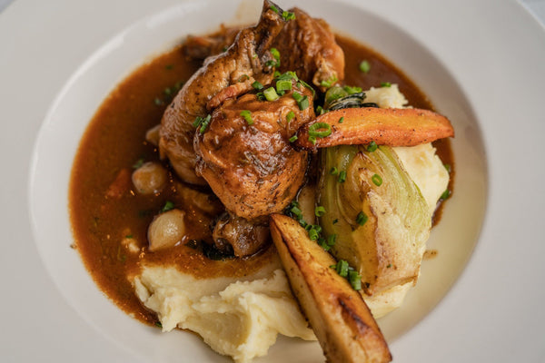 Coq au vin with bacon and onions